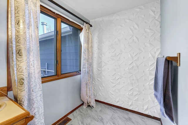 bathroom featuring marble finish floor, baseboards, and visible vents