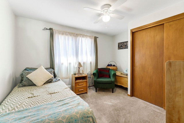 bedroom with a closet, light carpet, and ceiling fan