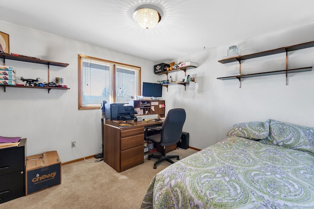 bedroom with light colored carpet and baseboards