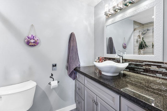 full bathroom with toilet, a shower stall, backsplash, and vanity