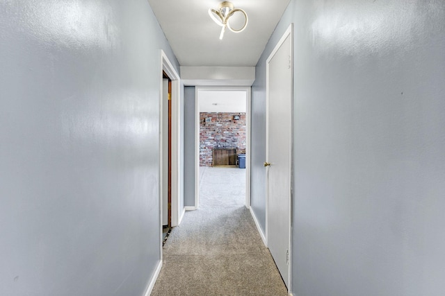 corridor with carpet floors and baseboards