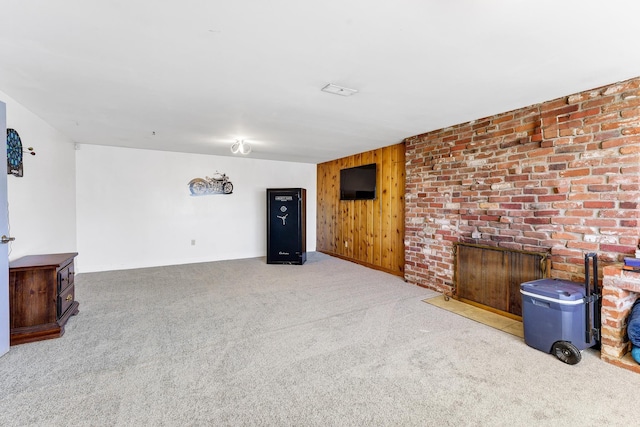 unfurnished living room featuring carpet floors and wooden walls