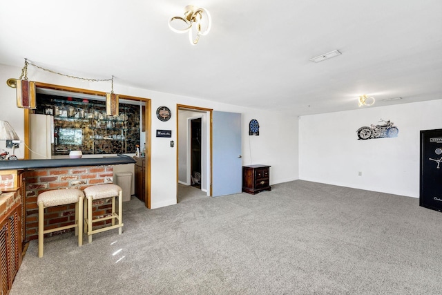 unfurnished living room featuring carpet floors and a dry bar