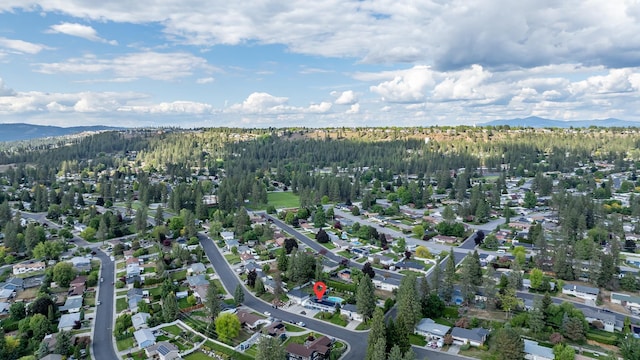 6514 N Sutherlin St, Spokane, WA 99208 - aerial view of property and surrounding area featuring a mountain backdrop and a heavily wooded area