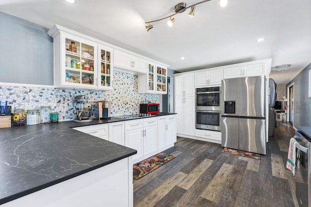 6514 N Sutherlin St, Spokane, WA 99208 - kitchen with appliances with stainless steel finishes, dark countertops, backsplash, white cabinets, and recessed lighting