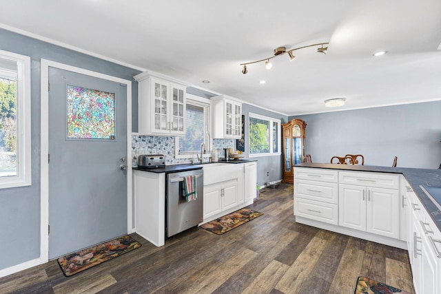 kitchen featuring decorative backsplash, dishwasher, dark countertops, dark wood finished floors, and glass insert cabinets