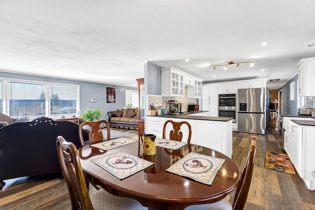 dining space featuring dark wood-style flooring and recessed lighting