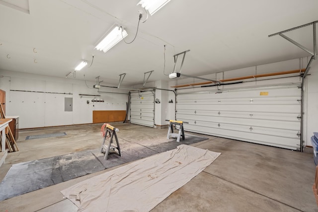 garage with electric panel and a garage door opener