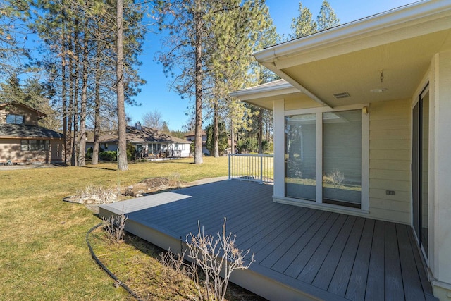 wooden deck featuring a yard