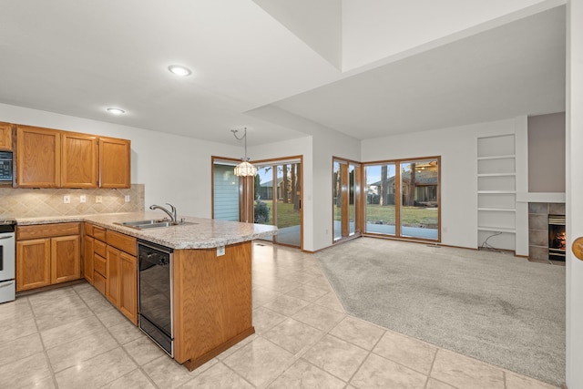 kitchen with a tile fireplace, light colored carpet, a peninsula, black appliances, and a sink