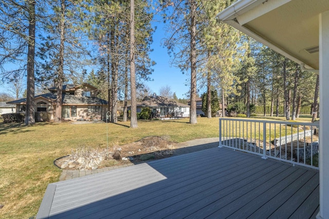 wooden terrace with a lawn