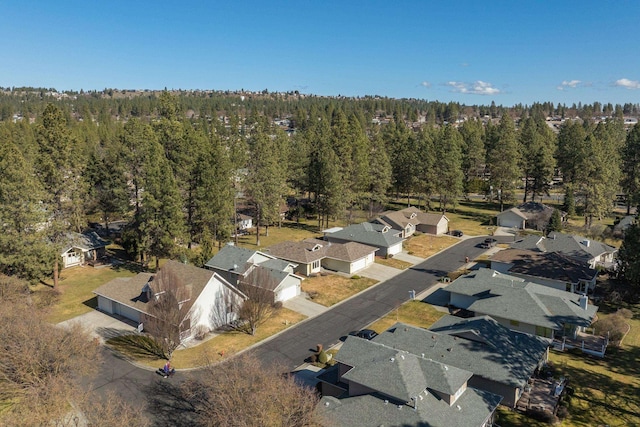 drone / aerial view with a residential view and a view of trees