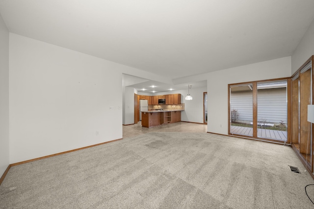 unfurnished living room with light carpet, baseboards, visible vents, and recessed lighting