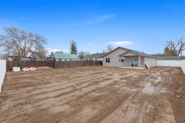 back of house featuring a fenced backyard