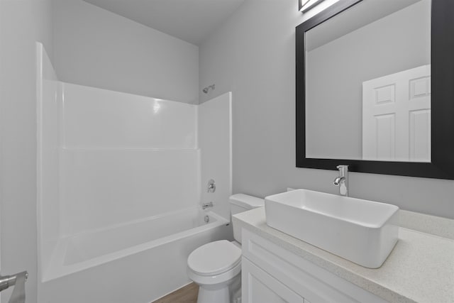 bathroom with toilet, shower / washtub combination, wood finished floors, and vanity