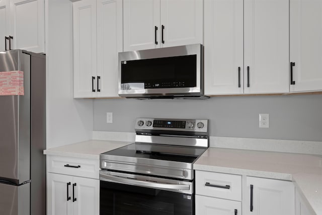 kitchen featuring white cabinetry, appliances with stainless steel finishes, and light countertops