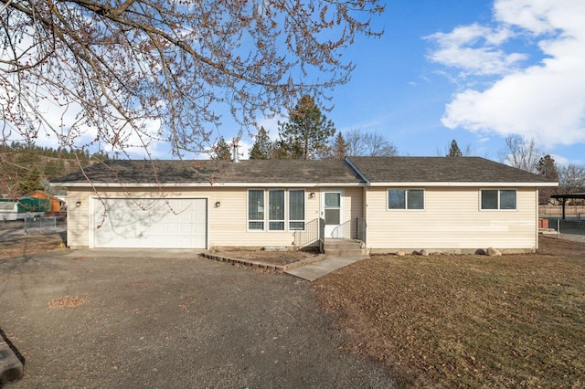 ranch-style home with a garage, driveway, and fence