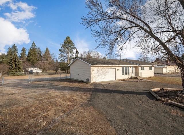 ranch-style house with driveway, an attached garage, and fence