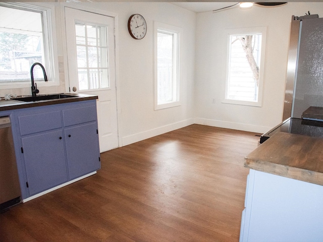 kitchen with dark wood-style floors, a sink, freestanding refrigerator, and dishwasher