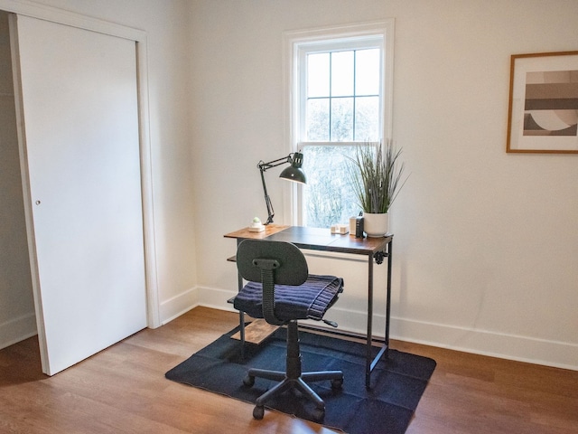 home office featuring baseboards and wood finished floors