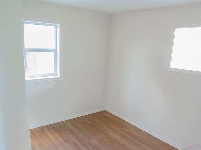 empty room with light wood-style floors and baseboards