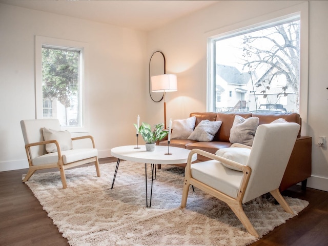 living area with wood finished floors and baseboards