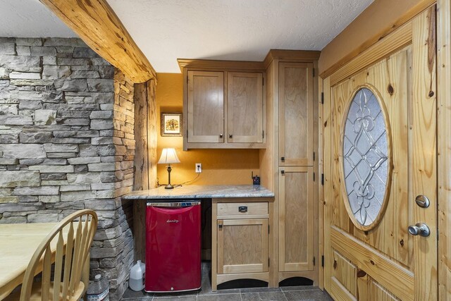 kitchen featuring a textured ceiling and light countertops