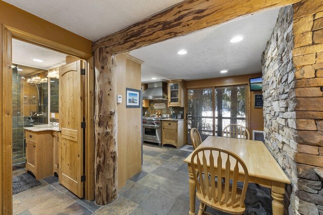 dining room with a textured ceiling, stone finish floor, and recessed lighting