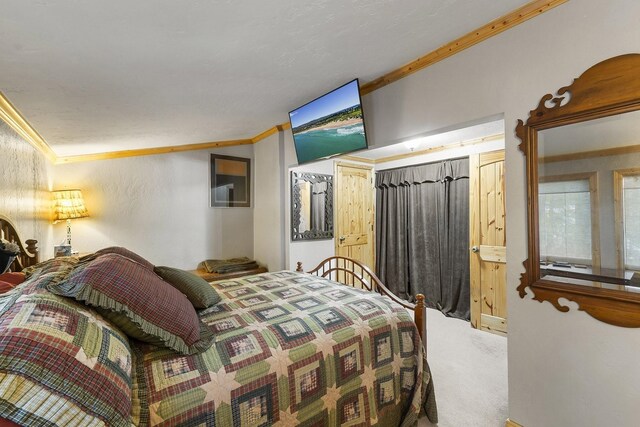 carpeted bedroom with ornamental molding