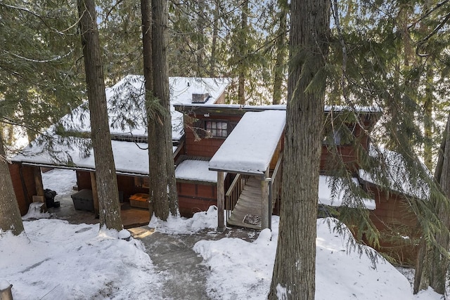 view of snow covered exterior with a garage