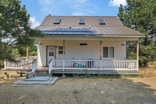 view of front of house featuring a porch, a standing seam roof, and metal roof