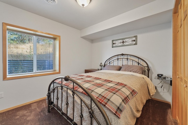 bedroom featuring carpet and baseboards