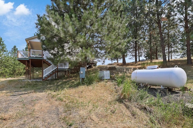 view of yard with stairs and a deck