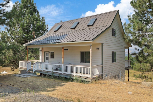 view of front facade with a standing seam roof, covered porch, and metal roof