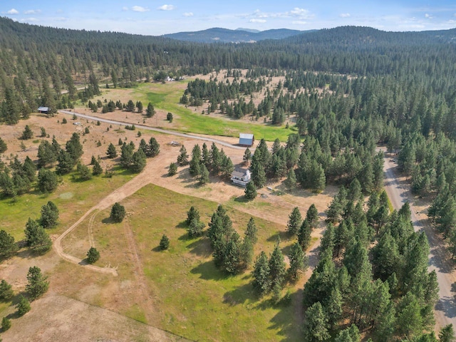 aerial view with a wooded view and a mountain view