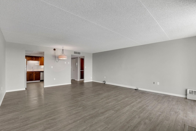 1311 S Westcliff Pl Unit 509, Spokane, WA 99224 - unfurnished living room with dark wood-style flooring, baseboards, a textured ceiling, and a sink