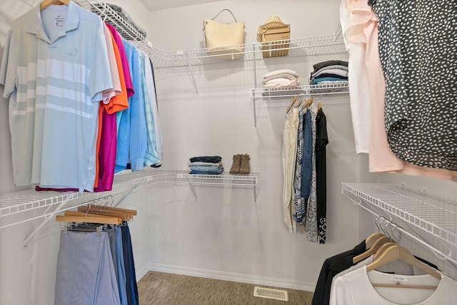 spacious closet featuring visible vents and wood finished floors