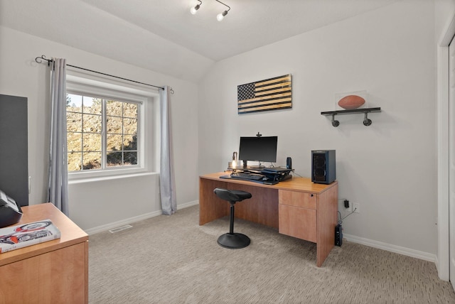 office space featuring lofted ceiling, light colored carpet, visible vents, and baseboards