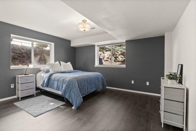 bedroom with baseboards and wood finished floors