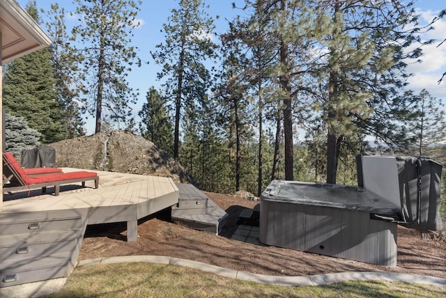 view of yard with a deck and a hot tub