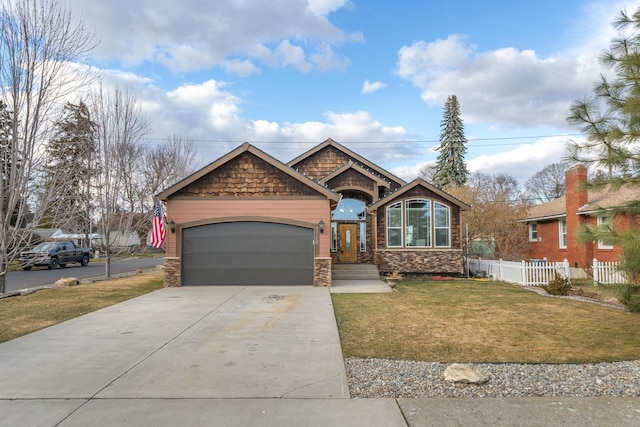 view of front of home featuring driveway, a front lawn, an attached garage, and fence