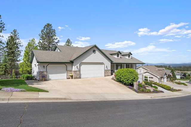 view of front of house with an attached garage, a shingled roof, and concrete driveway