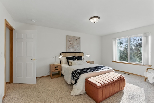 carpeted bedroom with baseboards and visible vents