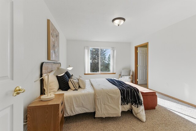 carpeted bedroom with baseboards