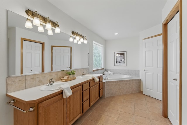 bathroom with double vanity, a bath, a sink, and tile patterned floors