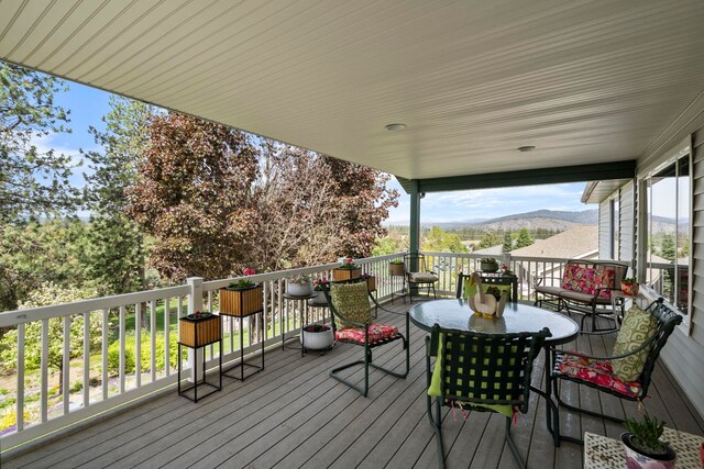 wooden deck with a mountain view