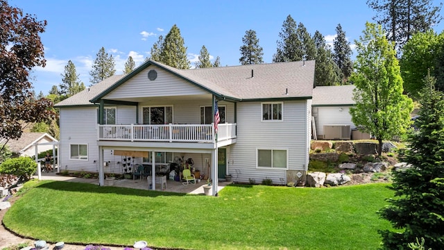 rear view of property featuring a patio area and a yard