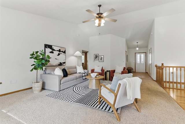 living area with a ceiling fan, high vaulted ceiling, and baseboards