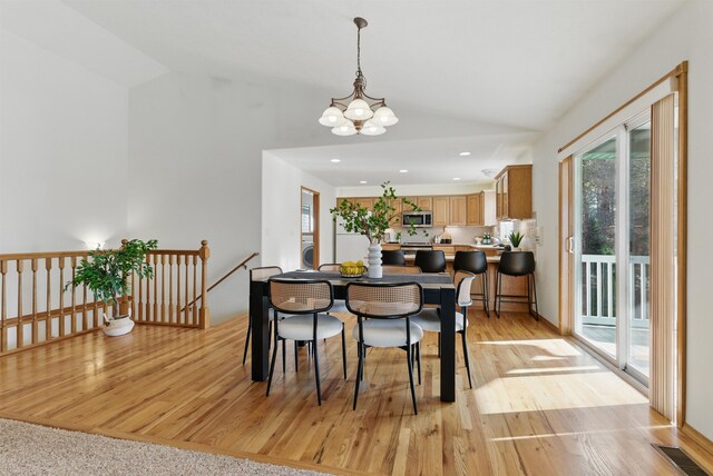 dining room with visible vents, vaulted ceiling, light wood-style floors, a notable chandelier, and recessed lighting