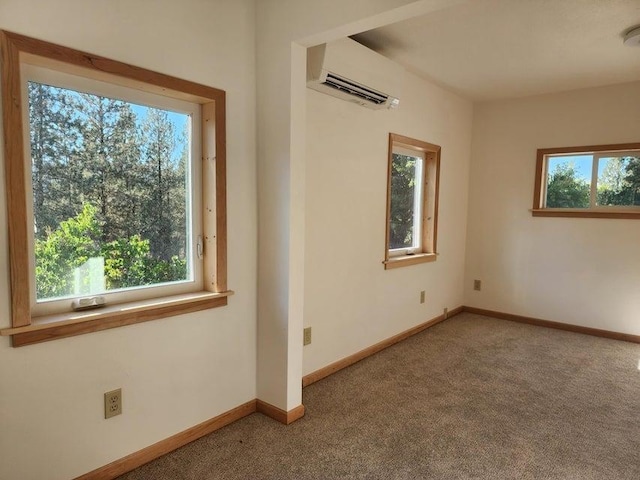 spare room featuring a wealth of natural light, carpet, and a wall mounted AC